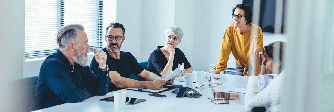 A board room with several professionals